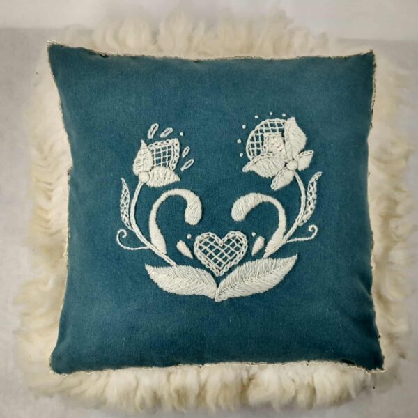 teal embroidered pillow